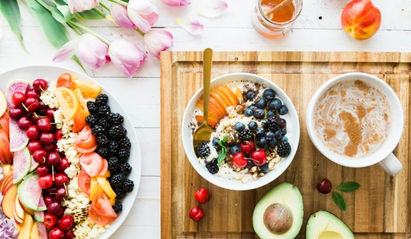Healthy Breakfast Spread With Bowl Of Oats, Plenty Of Fruits, And A Spiced Drink
