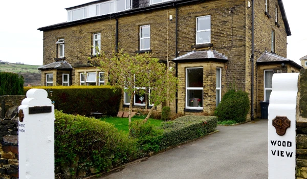 Entrance to Wood View a large stone house