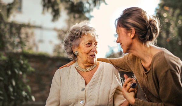 Younger Woman With Arm Around Older Woman