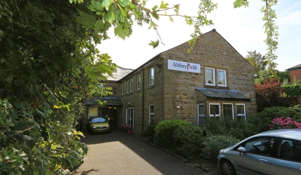 View of the entrance of Abbeyfield House with an Abbeyfield sign on the side